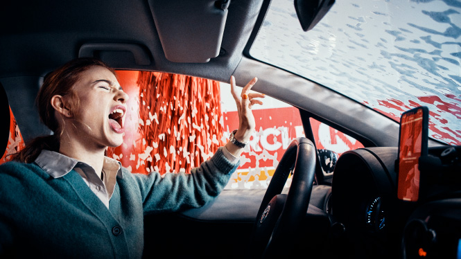 A woman sitting in a car during a Circle K car wash