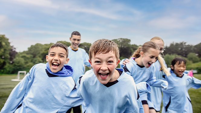 A group of kids smiling to the camera 