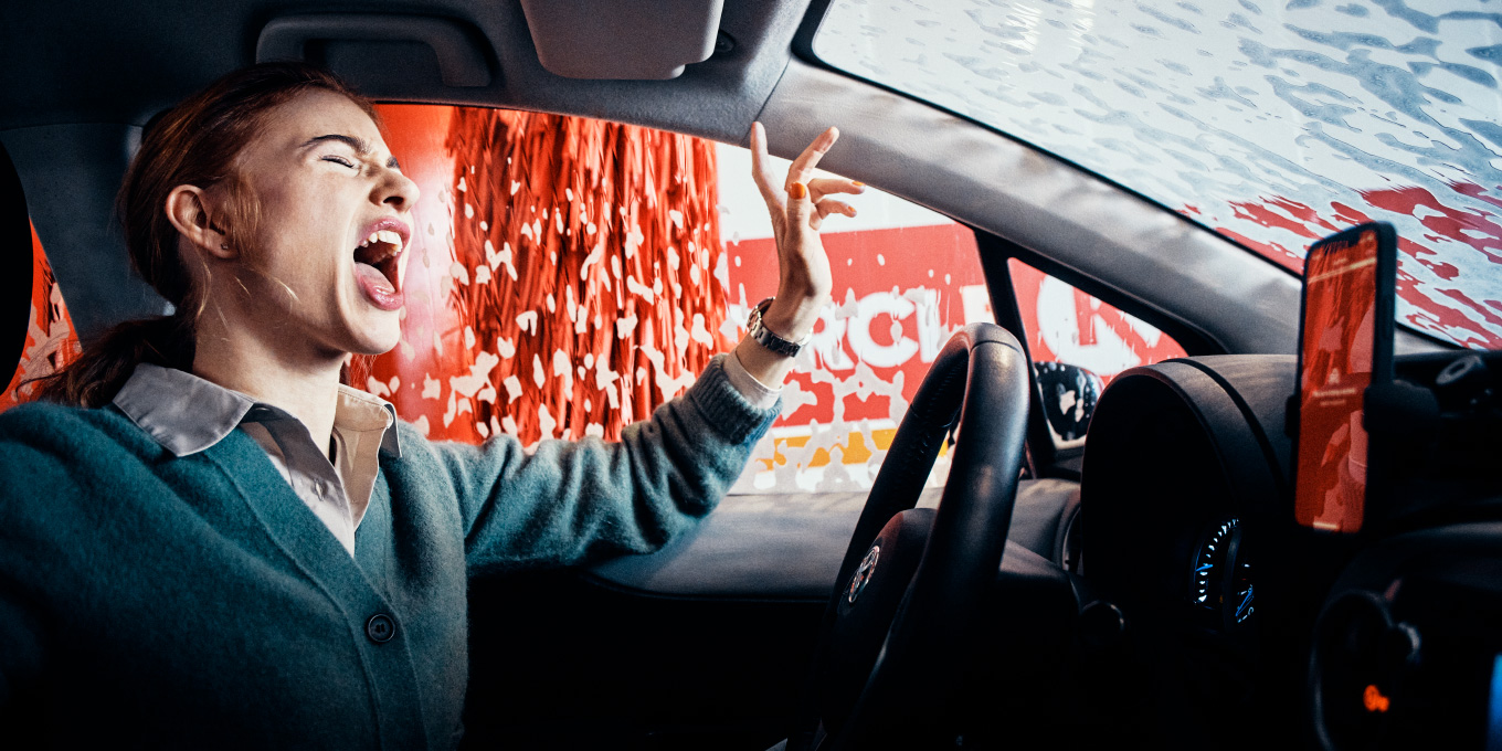 A woman sitting in a car during a Circle K car wash