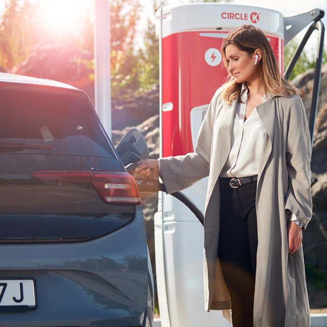 Woman charging an electric car