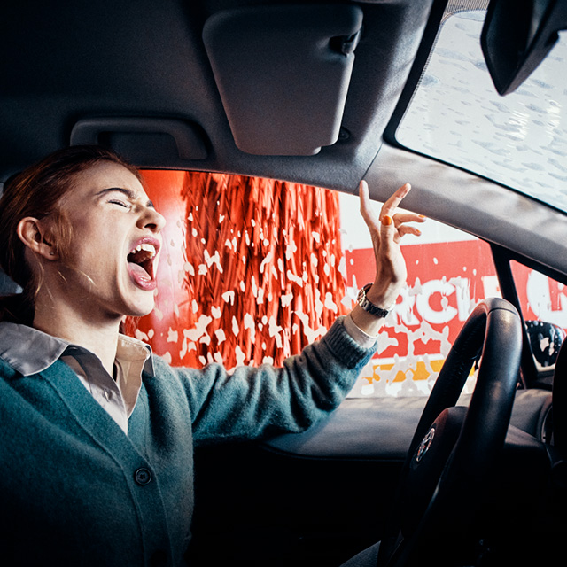 A woman sitting in a car during a Circle K car wash