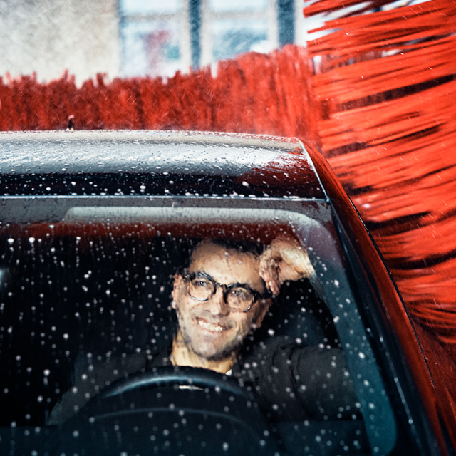 A man sitting in a car during a Circle K car wash