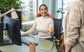 Woman happily showing person her Circle K card